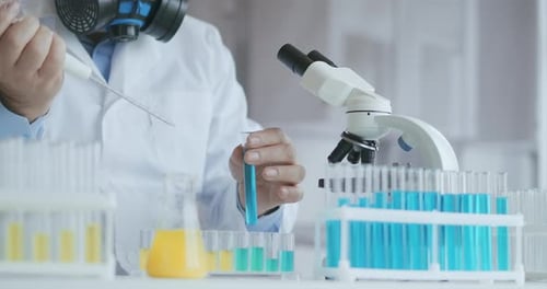 Scientist Experiments with Chemicals in Laboratory Environment