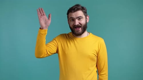 Man Waving Hello Against a Blue Background
