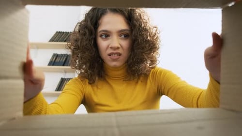 Disappointed Shocked Frustrated Woman Opening Carton Box at Home and Looking Inside