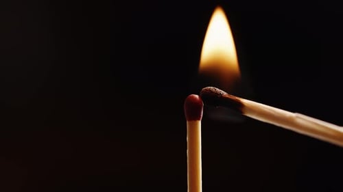 Close Up of Matches Igniting on Black Background