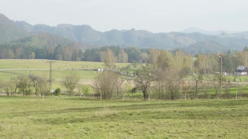 A View of Nature, Small Residential Village on the Side and Hills and Mountains in the Background.