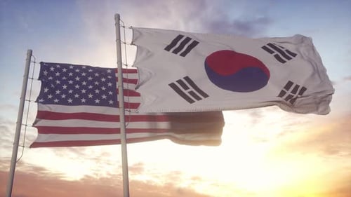United States and South Korea Flags Waving at Sunset