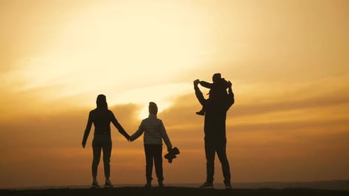 Happy Family Parents and Childrens Silhouettes Playing on Park
