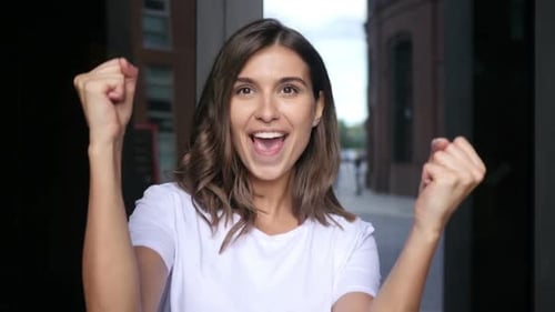 Woman Celebrates Success in City Location