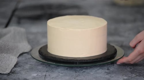 Close Up of Woman Hands Making Sweet Cake with White Cream and Biscuit