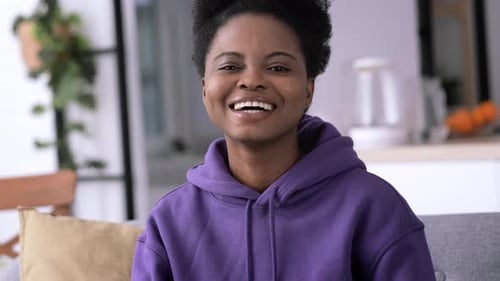 Smiling Woman in Purple Hoodie Indoors