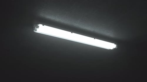 La iluminación fluorescente doble enciende el techo en un edificio industrial