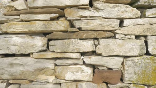 Stone plates arranged in wall slow tilting 4K 2160p UHD footage - Stone wall made of natural compone
