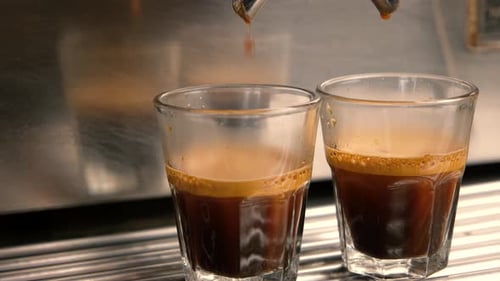 Fresh Espresso Pouring Into Two Clear Glasses