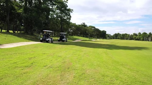4K Aerial view group of Asian people golfing on at golf course in summer sunny day.