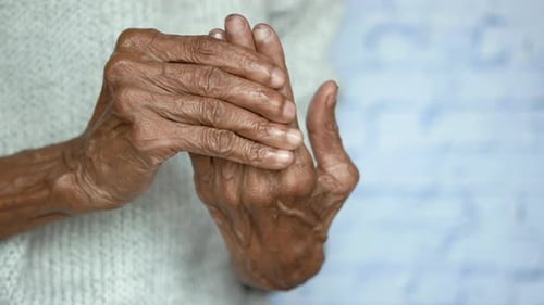 Close Up of Senior Hands Massaging