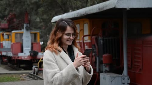 Young Girl with Glasses Writes a Message