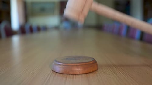 Gavel Tapped in Courtroom for Order and Justice