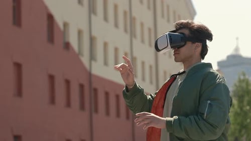 Stylish Guy Using VR Goggles for 3d Gaming Outdoors