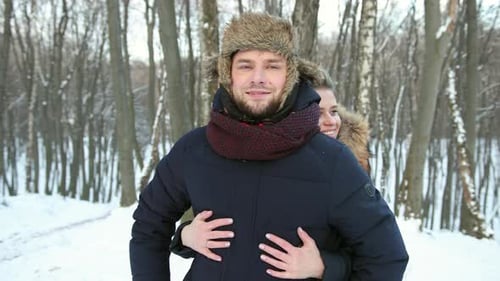 Woman Hugging His Close Up in Snowcovered Forest