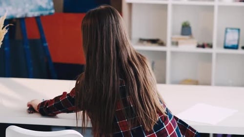 Young Girl Drawing with Colored Pencils at Home