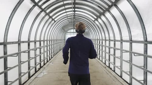 Running Man In Sportswear Workout Before Triathlon Sprinting In Glass Tunnel