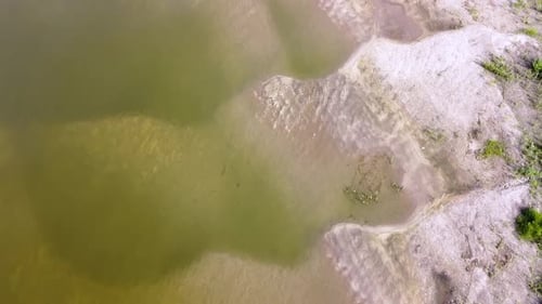 A beautiful sandy river coast. Big sand dunes under transparent water