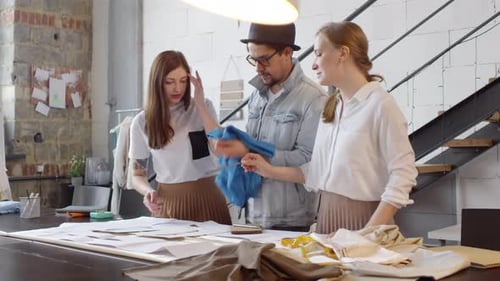 Fashion Designers Discussing Fabric in Sewing Studio