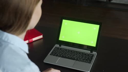 Businesswoman Video Chatting Online on Laptop with Green Screen in Office. Corporate Worker Call