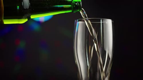 Beer Poured into Glass on Party Background