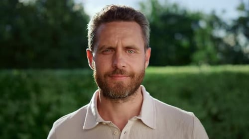 Man Smiling Directly into Camera Outdoors