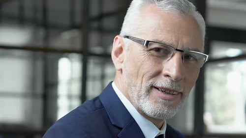 Portrait d'un homme d'affaires respectable senior souriant à la caméra, directeur de la société