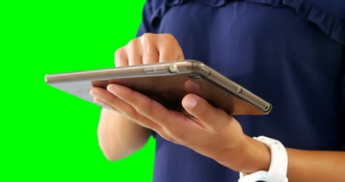 Woman using digital tablet against green screen 4k