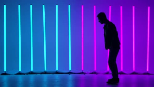 Breakdancing Acrobatic Elements Performed By Professional Dancer Against the Backdrop of Bright
