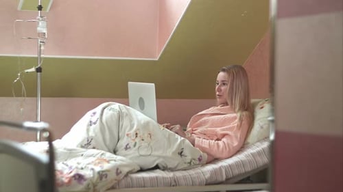 Young Woman Using Laptop Having Video Chat on Hospital Bed