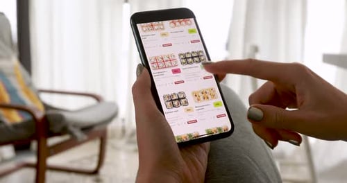 Woman Scrolls Sushi Options on Smartphone App