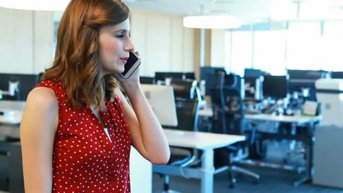 Woman Talking on Phone in Modern Office