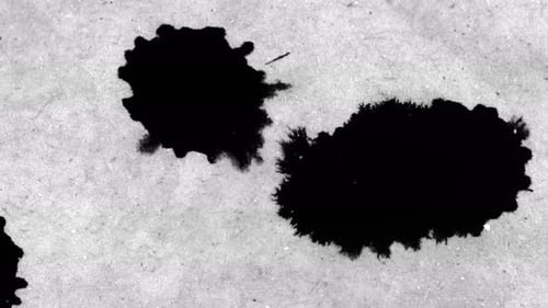 Ink Droplets Forming Abstract Blots on Paper