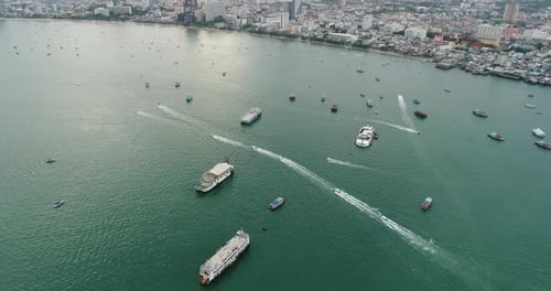 Aerial view of speed boats on the sea near beach city