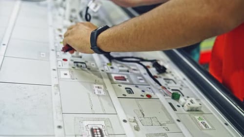 Technician Working on Electrical Wiring at Factory
