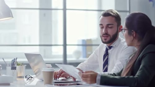 Colleagues Working on Laptop in Office