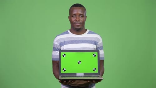 Young Adult Holding Laptop with Green Screen