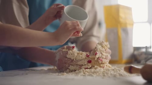 Woman and Child Baking Dough in a Kitchen