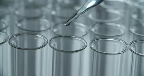 Pipette Dripping Liquid into Test Tubes Close Up