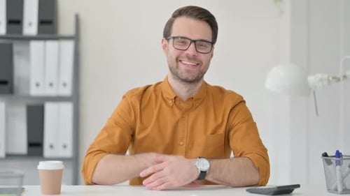 Man Giving Thumbs Up in Office Setting