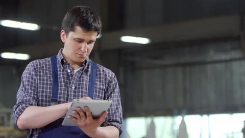 Man Using Touchscreen Tablet at Workplace
