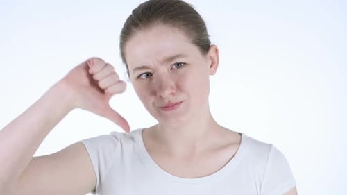 Woman Gives Thumbs Down Gesture in Studio