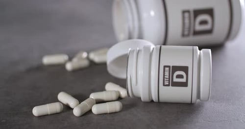 Vitamin D Supplements with Pill Bottles and Capsules