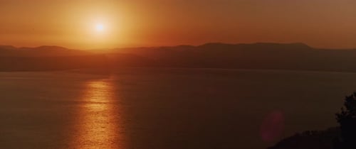 Beautiful landscape with sunset over the big lake and the mountains