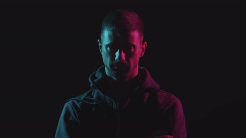 Man With Intense Look Under Neon Lights