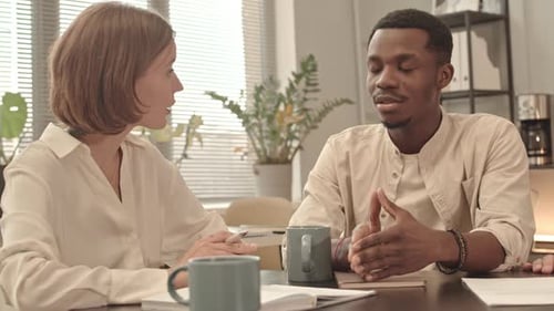 Young Adults Discuss Business in Modern Office Space