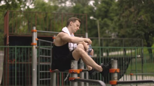 Athletic Body Shape Guy Relax at Outdoor Gym