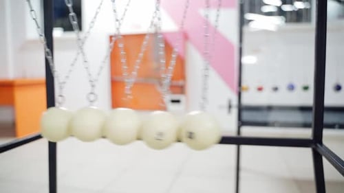Newton's cradle showing laws of physics in motion. Museum of Science