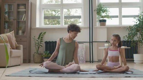 Woman and Girl Doing Yoga at Home