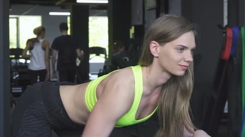 Woman Lifting Dumbbell in a Gym